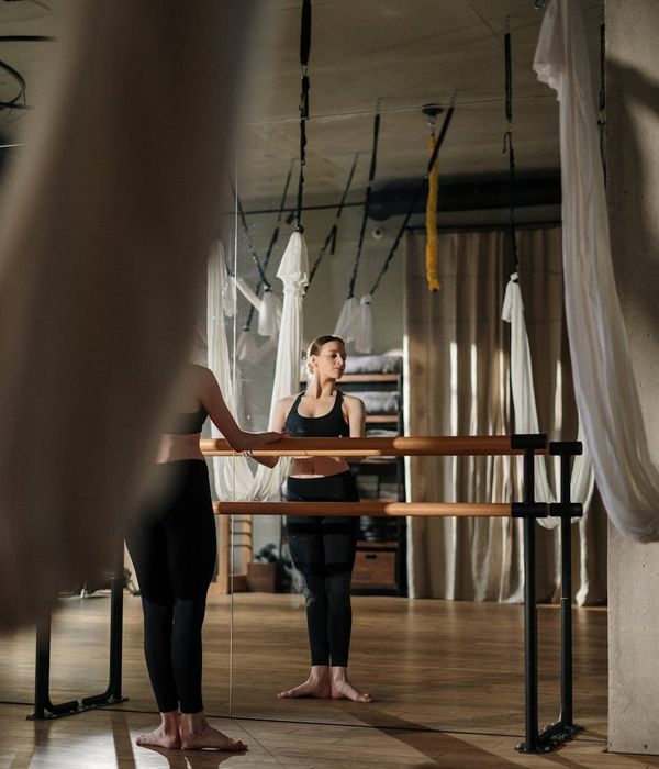 Woman in a peaceful yoga pose in a modern, calm studio.